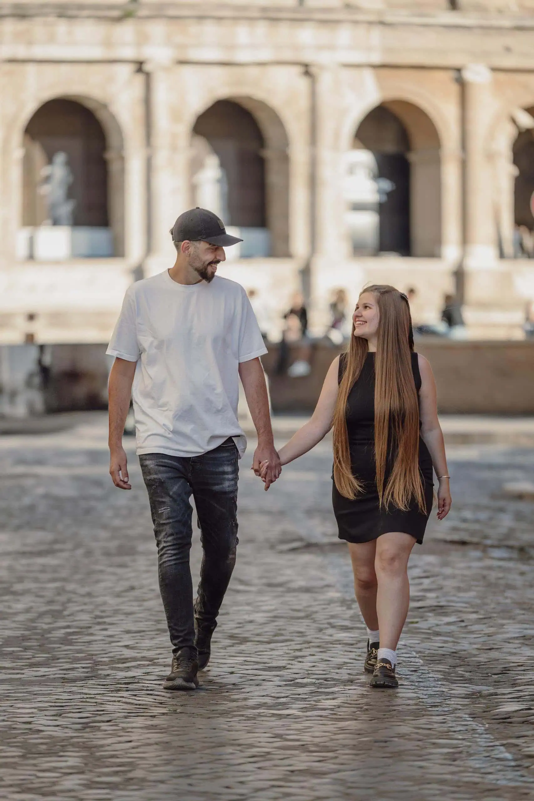 Couple holding hands walking colosseum - Rome by Finzi
