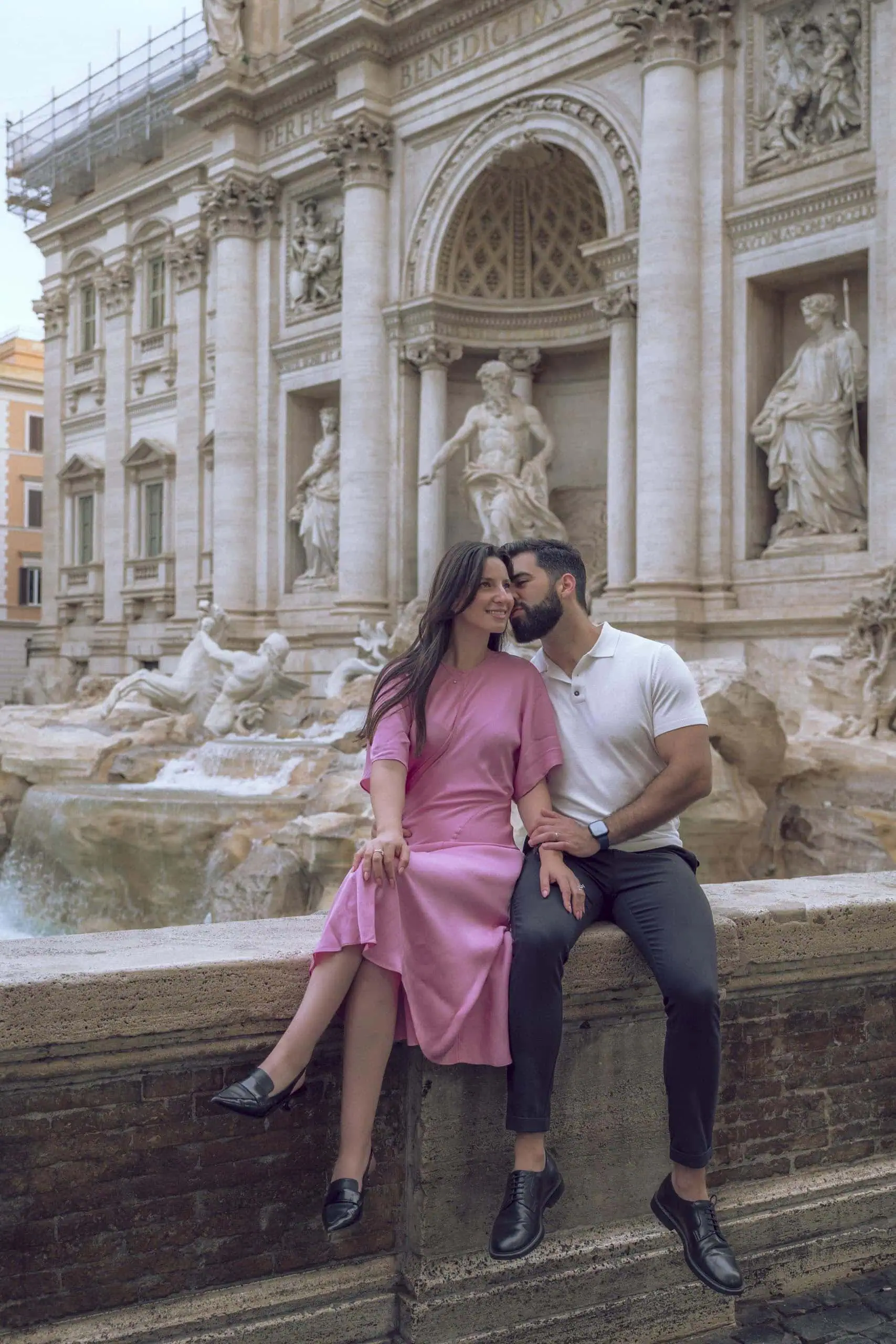 Couple kiss on cheek trevi fountain Rome photographer finzi - Rome by Finzi