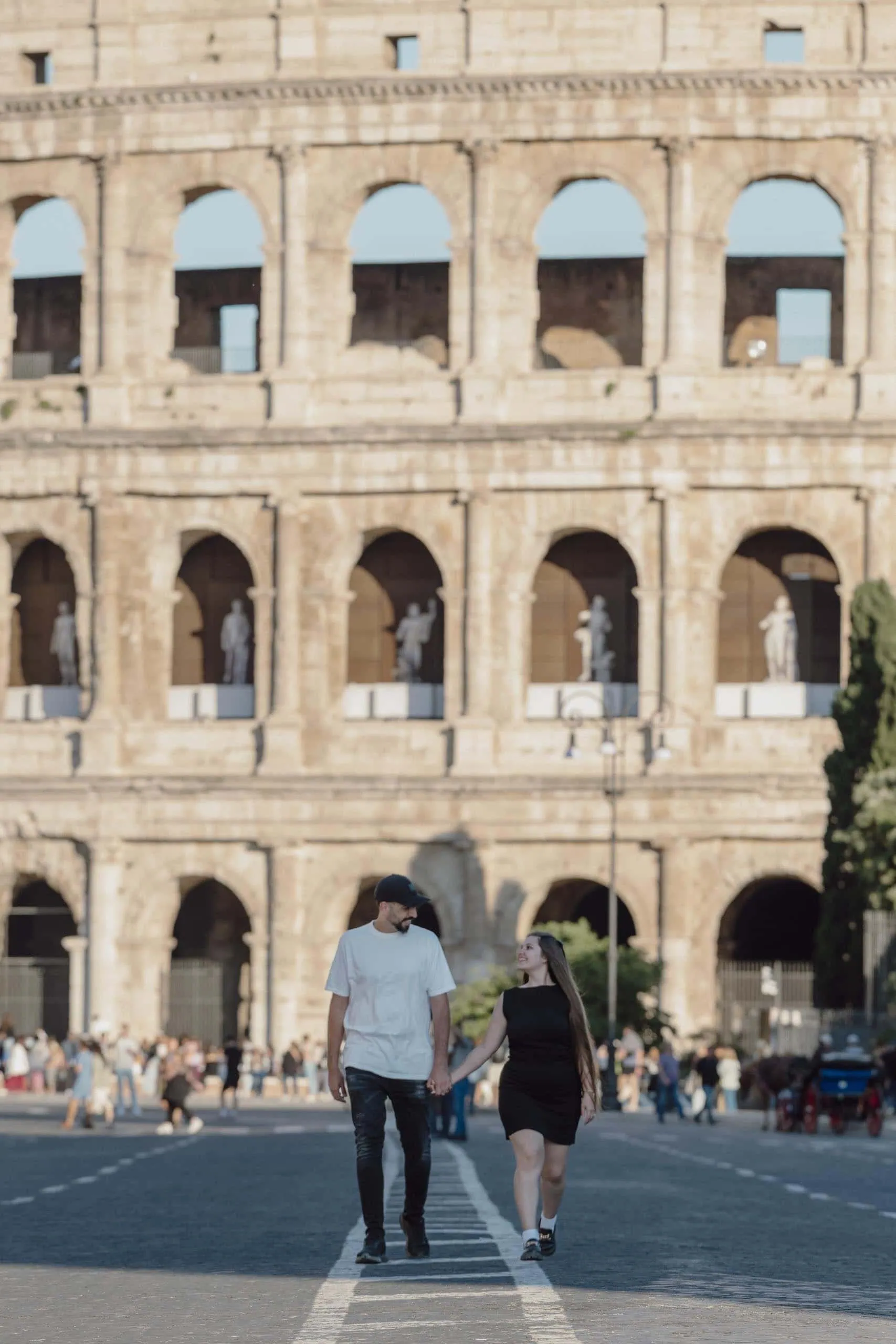 Couple strolling colosseum arches Rome - Rome by Finzi