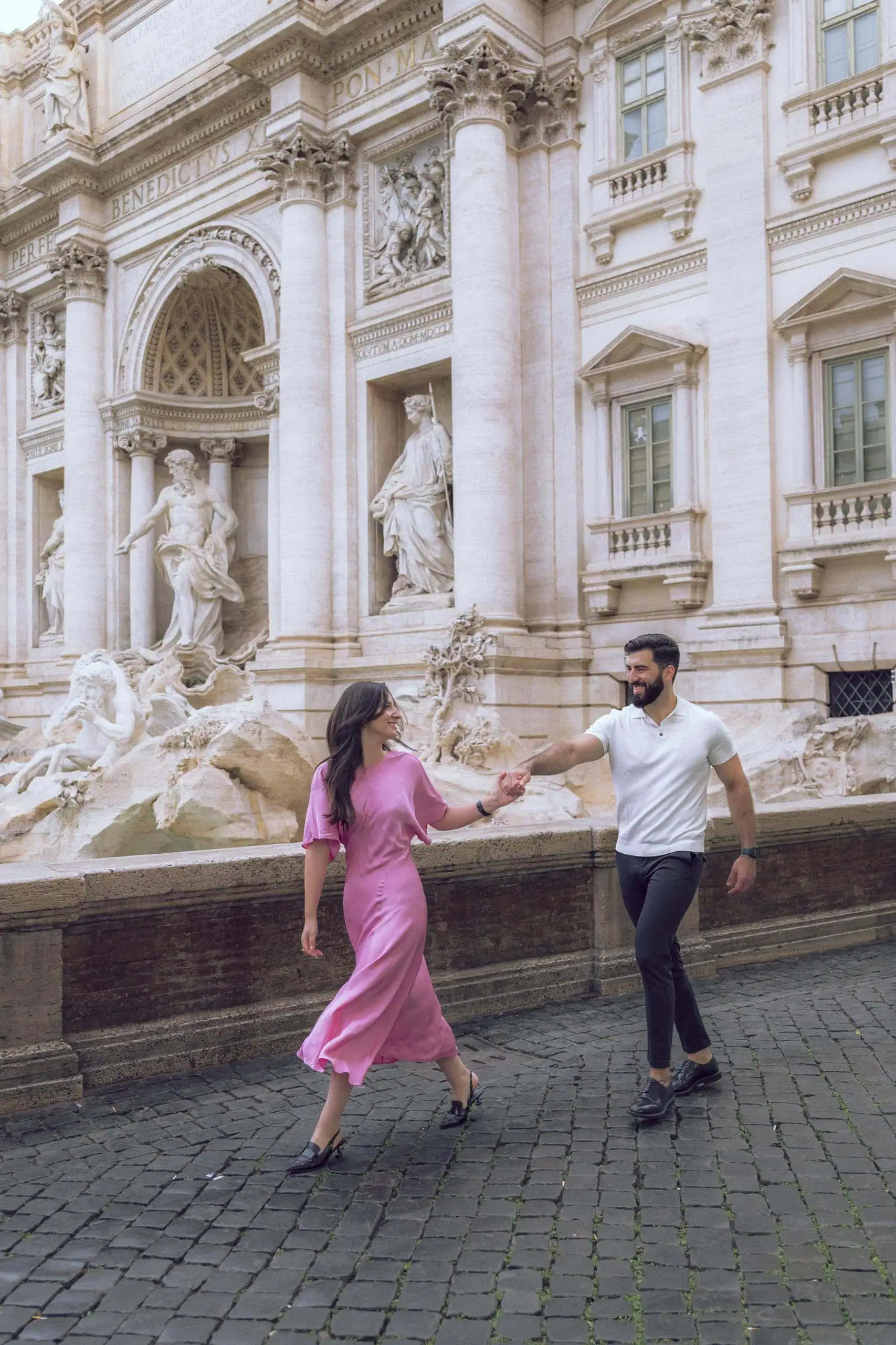 Couple walking hand in hand trevi fountain Rome photographer finzi - Rome by Finzi