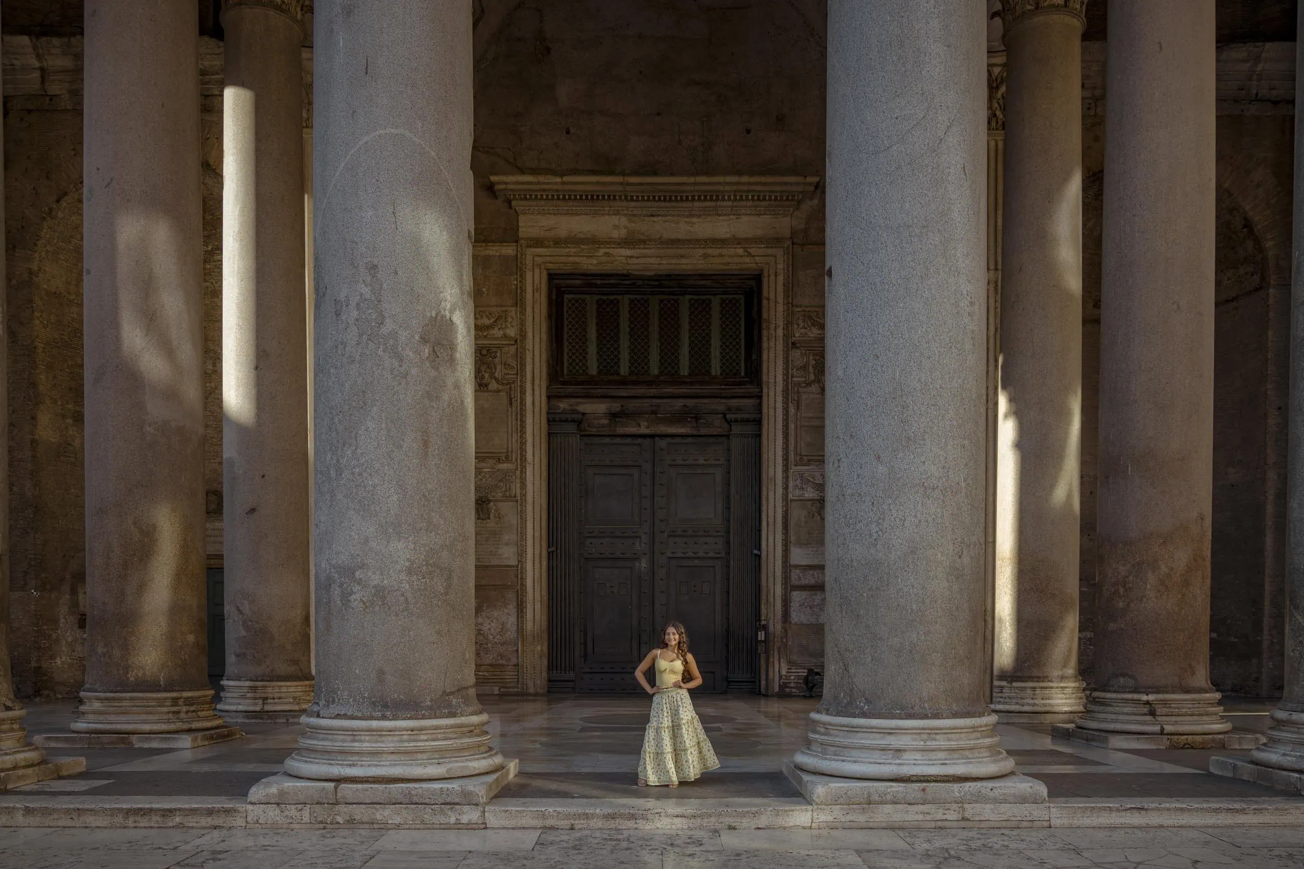 Woman posing between pantheon portico columns Rome - Rome by Finzi